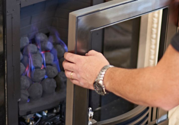 An engineer servicing a gas fire